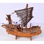 A Wooden model of a Chinese junk 18 x21 cm.