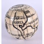 A CONTEMPORARY CARVED SCRIMSHAW BONE GLOBE COMPASS. 10 cm wide.