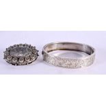 AN ANTIQUE SILVER BROOCH and a bangle. 30 grams. Largest 6 cm x 4.75 cm. (2)