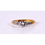 AN EDWARDIAN 18CT GOLD PLATINUM AND DIAMOND SOLITAIRE RING. 2.2 grams.