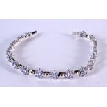 A 14CT WHITE GOLD AND TANZANITE BRACELET. Stamped 14K, 19cm long, weight 11.8g