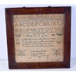 A framed sampler dated 1860 31 x 32 cm.