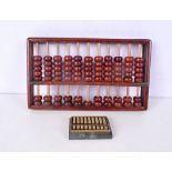 A Chinese wooden abacus together with a small brass abacus 30 x 17 cm(2).