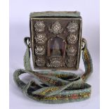 A 19TH CENTURY TIBETAN SILVER TRAVELLING BUDDHISTIC SHRINE decorated with repousse motifs. 15 cm squ