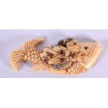 A JAPANESE CARVED BONE FISH PLAQUE. 7 cm x 3.25 cm.