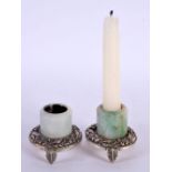 A PAIR OF 18TH/19TH CENTURY CHINESE CARVED JADE ARCHERS RINGS with silver mounted, converted to cand