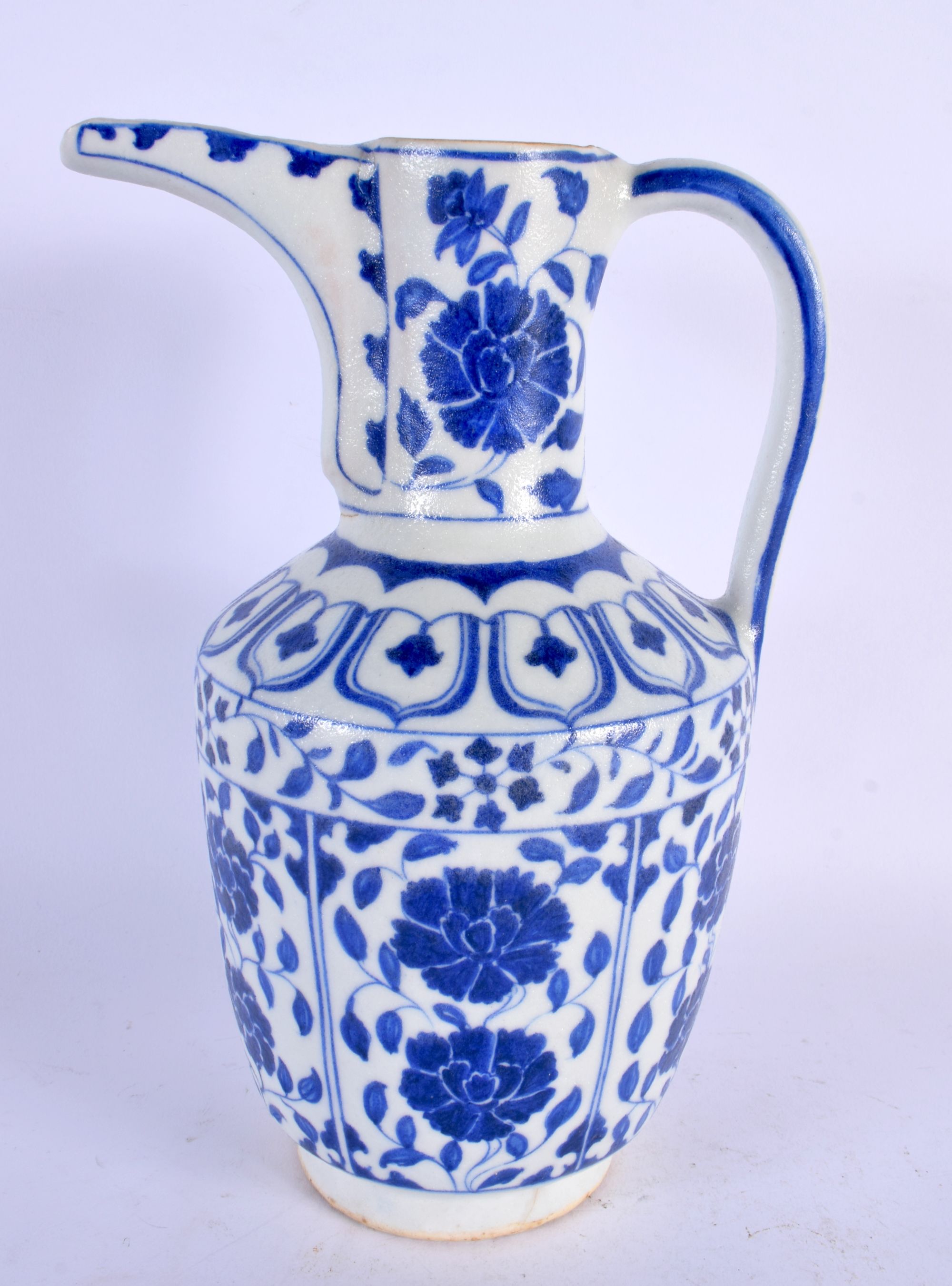 A TURKISH ISLAMIC BLUE AND WHITE WATER JUG. 27 cm high.