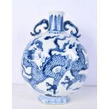 A Chinese porcelain blue and white moon vase twin handled decorated with a dragon. 30 cm.