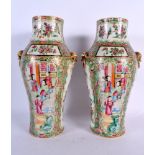 A PAIR OF 19TH CENTURY CHINESE CANTON FAMILLE ROSE VASES painted with figures. 25.5 cm high.