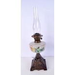 An aesthetic movement oil lamp with a metal base and a hand painted glass reservoir decorated with f