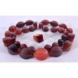 A CHERRY AMBER TYPE NECKLACE WITH MATCHING RING. Ring size M, Necklace 90cm long (2)