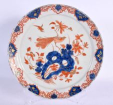 A RARE 18TH CENTURY DELFT IMARI TIN GLAZED ENAMEL PLATE painted with a bird perched amongst flowerin
