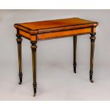 A VICTORIAN AMBOYNA AND EBONISED FOLDING CARD TABLE of earred oblong form with gilt metal mounts,