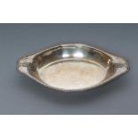 A SILVER SERVING DISH, maker's mark GH, Sheffield 1930, of oval form, the everted rim with cast