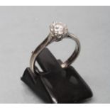 A SOLITAIRE DIAMOND RING, the round brilliant cut stone of approximately 0.50cts, claw set to a