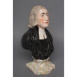 A STAFFORDSHIRE POTTERY BUST OF WESLEY, late 19th century, the clergyman wearing a white stock and