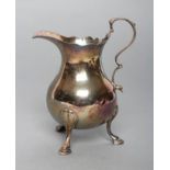 A GEORGE II SILVER CREAM JUG, maker probably Benjamin Sanders, possibly London 1740, of baluster