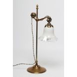 A BRASS DESK LAMP, the plain turned stem issuing an adjustable branch hanging an opaque glass
