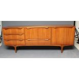 A MID 20TH CENTURY RETRO "S" FORM TODMORDEN TEAK SIDEBOARD, the fascia with drop down central door