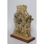 A BRASS CATHEDRAL SKELETON CLOCK, 20th century, the twin fusee movement striking on a gong,