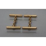 A PAIR OF CUFFLINKS, stamped 18, with plain cylinder links, 14.59 total (Est. plus 21% premium