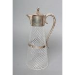 A LATE VICTORIAN SILVER AND GLASS CLARET JUG, maker J.N. Mappin, Birmingham 1887, of wrythen