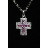 A CROSS PENDANT to match the previous two lots, set with ten square cut pink sapphires, stamped 750,