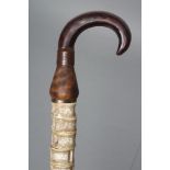A SHARK VERTEBRAE WALKING STICK, the fifty one bones in stained wood collar and metal handle and