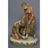 A ROYAL DUX BISQUE PORCELAIN FIGURE GROUP, early 20th century, modelled as two skaters, the young