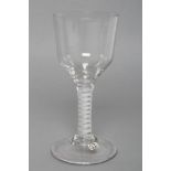 A GLASS GOBLET, mid 18th century, the ogee bowl on a double spiral opaque stem and domed foot, 7 1/