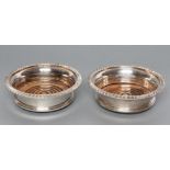 A PAIR OF SILVER BOTTLE COASTERS, maker Roberts & Belk, Sheffield 1973, of flared cylindrical form