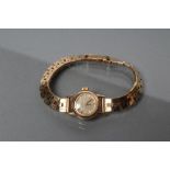 A LADY'S 9CT GOLD OMEGA WRISTWATCH, the champagne dial with gilt batons, the seventeen jewel