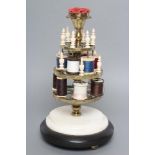 A VICTORIAN BRASS BOBBIN STAND comprising three graduated pierced trays with turned bone finials