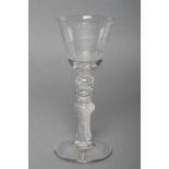 A WINE GLASS, c.1760, the round funnel bowl engraved with two flaming hearts resting on a plinth,