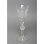 A TALL NEWCASTLE TYPE WINE GLASS, c.1770, the round funnel bowl Dutch engraved with two weavers at