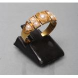 A VICTORIAN 18CT GOLD RING, the square panelled upper section gypsy set with split pearls,