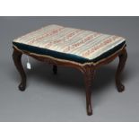 A VICTORIAN MAHOGANY DRESSING STOOL, the oblong seat upholstered in a striped silk, with waved rails