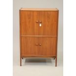 A JOHN HERBERT FOR YOUNGER TEAK COCKTAIL CABINET, mid 20th century, of oblong form with dished