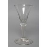 A LARGE WINE GLASS, c.1750, the bell bowl on a plain stem and conical foot, 6 1/4" high (