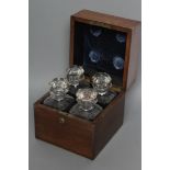 A LATE VICTORIAN OAK FOUR BOTTLE DECANTER BOX of square section with Bramah lock, enclosing four