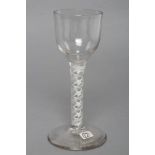 A WINE GLASS, mid 18th century, the ogee bowl on an opaque triple spiral stem and conical foot, 5