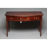 A GEORGIAN MAHOGANY SERVING TABLE, c.1800, of bowed form with reeded edged top, three frieze drawers