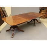 A VICTORIAN MAHOGANY EXTENDING TWIN PEDESTAL DINING TABLE, the reeded edged rounded oblong top