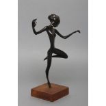 A HAGENAUER(?) BRONZE FIGURE OF A YOUNG AFRICAN FEMALE DANCER with gilded neck ring, on associated
