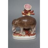 A VICTORIAN STAFFORDSHIRE POTTERY ELEPHANT SPILL VASE modelled standing with two free legs,