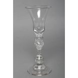 A LIGHT BALUSTER WINE GLASS, c.1745/50, the flared bell bowl with solid base on cushion and ball