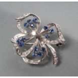 A SAPPHIRE AND DIAMOND OPEN FLOWER BROOCH with fourteen small circular cut sapphire stamens and