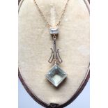 AN EDWARDIAN NECKLACE, the fine chain necklace fixed to an open back collet set square cut