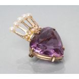 AN AMETHYST BROOCH, the facet cut heart shaped stone surmounted by a 9ct gold coronet with
