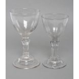 TWO SIMILAR GLASS SWEETMEATS, mid 18th century, one with moulded round funnel bowl on eight sided